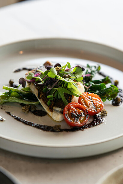 A beautifully plated gourmet fish and vegetable dish inspired by the Paleo diet, photographed in Tokyo, Japan