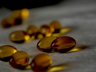 Detailed close-up of translucent softgel capsules, symbolizing nutritional vitamins