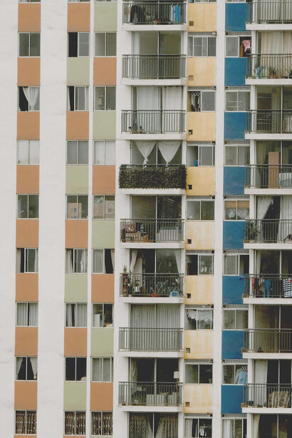 An urban residential building reflecting the stark contrast of housing inequality and overcrowded living conditions