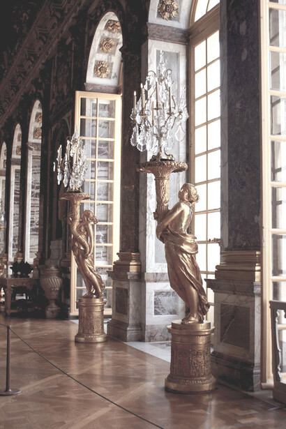 Ornate ceiling and chandeliers inside the Hall of Mirrors at the Palace of Versailles, located just outside Paris, France