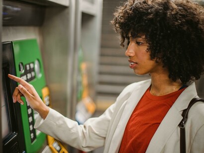 A woman withdrawing cash from an automated teller machine