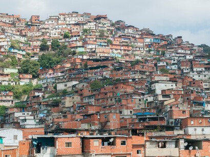 The dense sprawl of the slums underscores how economic collapse reshapes the lives of millions