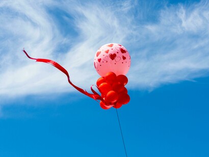 Colorful balloons floating freely against the open sky