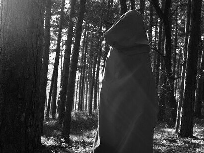 Shrouded in silence, the cloaked figure mirrors the unseen protectors who guard what lies hidden beneath the Earth