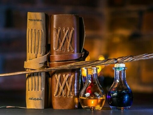 A wand, books and potions on a table, reflecting how familiar stories remain culturally and emotionally relevant