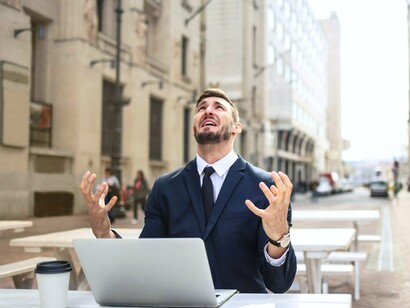A man in formals seemingly stressed about work, depicting how the pressures of the corporate world can take a toll on individuals, making them turn to unhealthy coping mechanisms