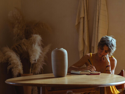 An elderly woman engaged in writing, capturing the quiet moments of self-inquiry and growth