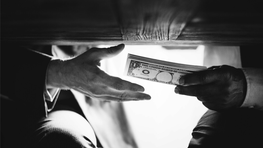 Hidden exchange of bills out of public view, capturing the corrupt dealings that diverted funds from real flood defences