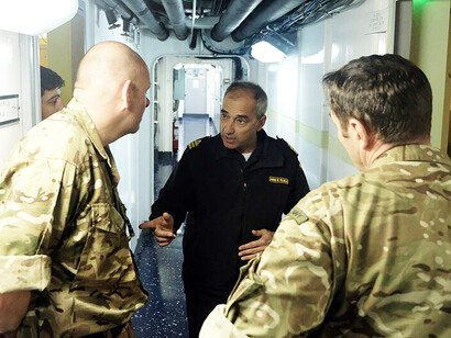 British Royal Navy officers meet with a Spanish Navy officer aboard the Spanish ship Castilla (L52) at Naval Station Rota, Cádiz, Spain, on Feb. 6, 2019, as part of an exercise focused on enhancing capabilities and strengthening ties with NATO maritime allies