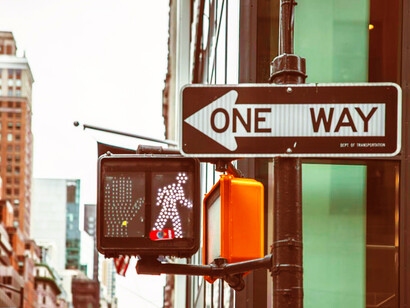 A street sign next to a traffic light in New York City, USA