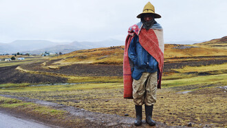 A Lesotho herder wears a Basotho blanket, a covering commonly worn, which has become a national symbol