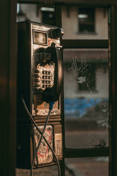 Inside an old public phone booth, where countless immigrants once reached out across borders