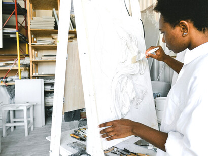 A woman artist inside her studio—a messy yet inspiring space that serves as her personal sanctuary