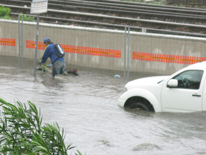 In Italy, people attempt to flee their vehicles as rising floodwaters trap cars on submerged streets