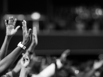 Hands lifted towards the sky in a moment of collective prayer