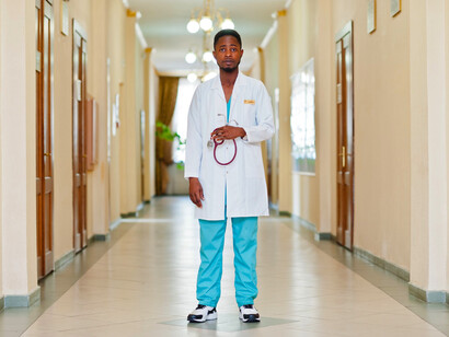 A doctor standing in the corridor, showing how the healthcare industry should thrive on the dedication and expertise of its professionals and provide quality care to patients