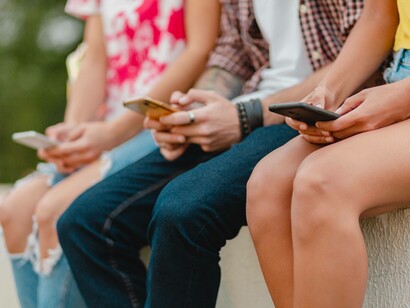 Gruppo di amici mentre usano gli smartphone