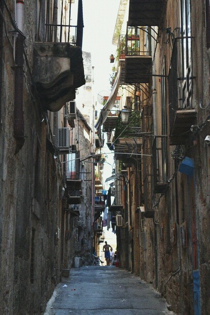 Lanterns and fluttering flags bring color to the historic streets of Napoli, Italy