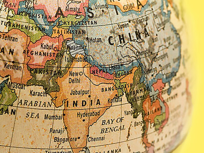 An old-style globe displaying the geographical positions of Pakistan, China, and India