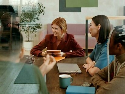 Young adults sitting together in discussion, underscoring the importance of youth dialogue in shaping solutions