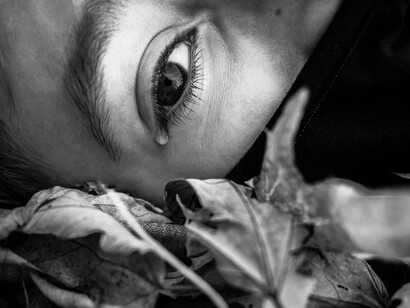 A tear rolling down, signifying how grief can manifest physically and tie us down