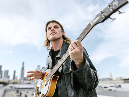 A musician with his guitar, reflecting how real performers are becoming a thing of the past