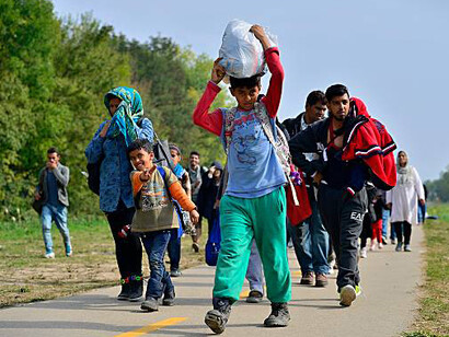 Refugees, including small children and families, on their journey