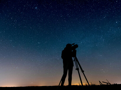 A person beneath the stars, embodying trust in the unseen path ahead