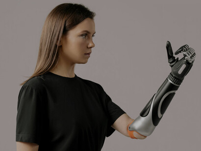 A woman with a bionic arm stands confidently, showcasing the possibilities of advanced prosthetic technology