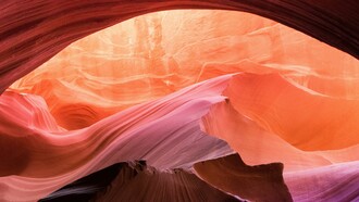 Sculpted by time, the canyon glows in pinks and oranges, nature’s own watercolor painting in motion