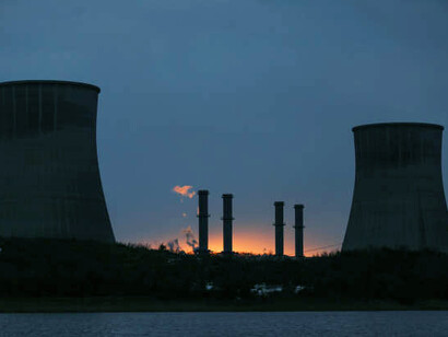 Nuclear energy plant illuminated at night, demonstrating the generation of power from nuclear reactors