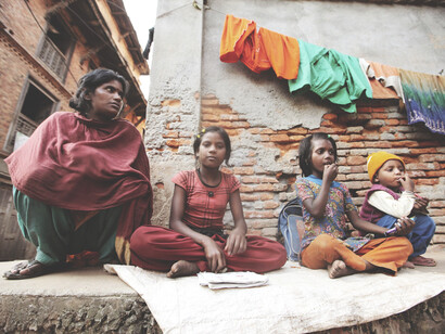 A group of people gathered in front of a building in rural Haldwani, Uttarakhand, India—highlighting visible signs of poverty and inequality