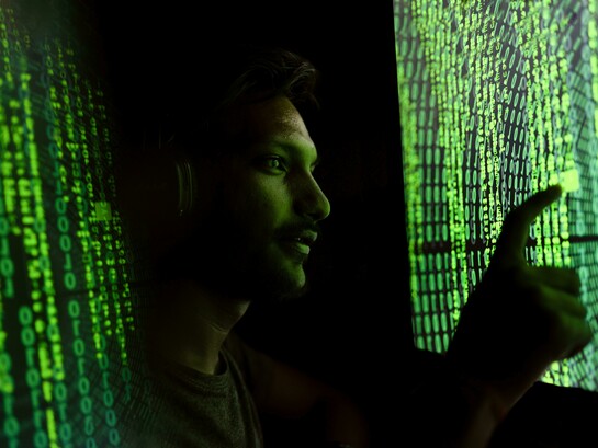 A person surrounded by floating algorithms symbolizes the overwhelming presence of AI in modern life