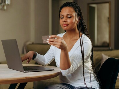 A consumer using a card to buy a product online. With the internet, it became even easier to advertise and sell products