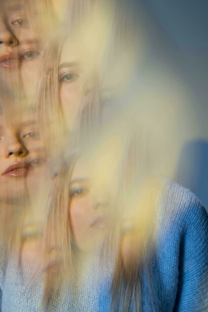 A distorted image of a woman dissolves into a maze, reflecting the quiet struggle of a mind finding its way through layers of thought
