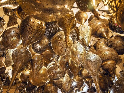 Decorative golden lamps for sale in a market in Morocco, exhibiting a symbol of the rich Moroccan culture and their local business