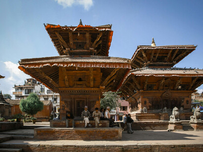 Visitors admire the facade of a Buddhist temple in Patan, Nepal