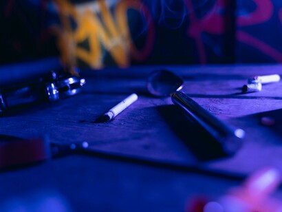 A table covered with drugs, syringes, and pills, symbolizing addiction and drug abuse
