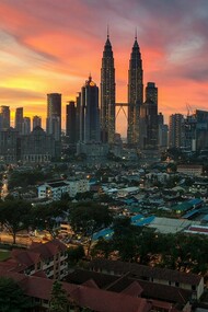 A captivating aerial view of Kuala Lumpur, Malaysia, at sunset, showcasing the city's blend of modern skyscrapers and traditional neighborhoods
