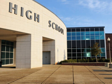 The entrance to the high school campus is located near the main street