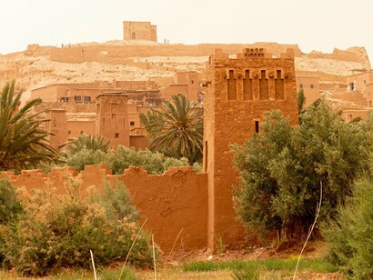 The historic ksar of Ait Ben Haddou rising from arid terrain, symbolising the Kingdom’s enduring relationship between environment and ambition