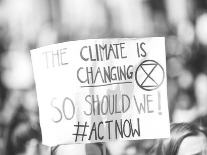 No climate justice without economic justice, recalls this placard held by protesters engaged in the fight for a fairer world