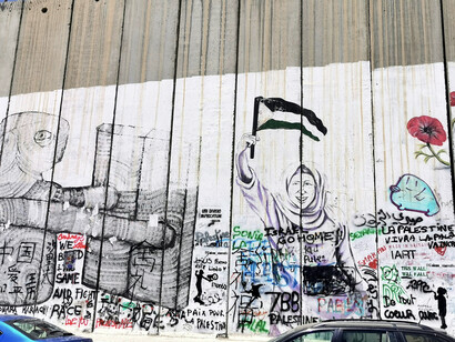 Words and images of protest on the separation wall, reflecting the connection between local acts of rebellion and worldwide support