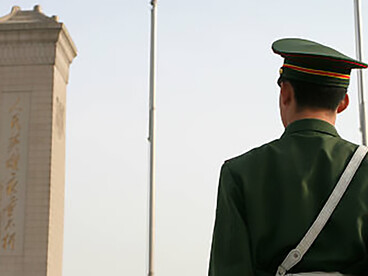 A Chinese soldier viewed from the back, showcasing China's military capabilities and cutting-edge technology