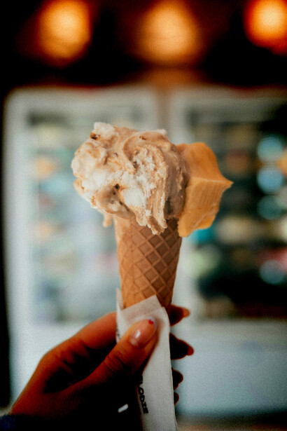 A close-up of a person holding ice cream cones