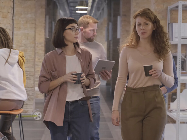 Colleagues engage in lively discussions, showcasing the vibrant energy that fuels a productive workplace