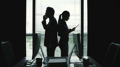 Two figures, one center of gravity: intimacy, image, and power converging behind closed glass