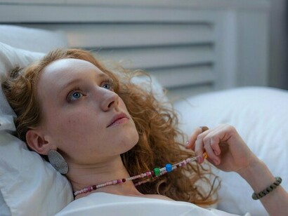 A woman lying in bed staring at the ceiling, illustrating how unresolved thoughts disrupt rest and peace