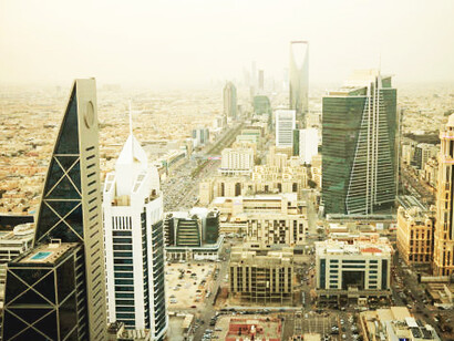An aerial panorama of downtown Riyadh, showcasing the skyscrapers of the Al Olaya Central Business District in the heart of Saudi Arabia's capital