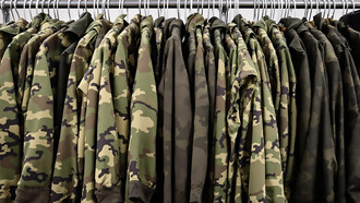 Military uniforms hanging on clothing rack